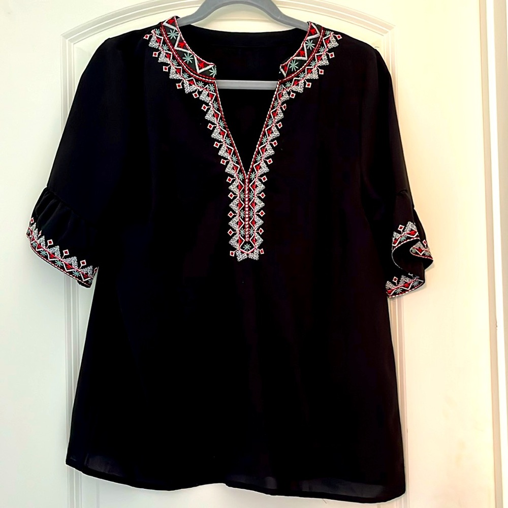 Medium black blouse with gorgeous embroidery detail on v-neckline and sleeves.